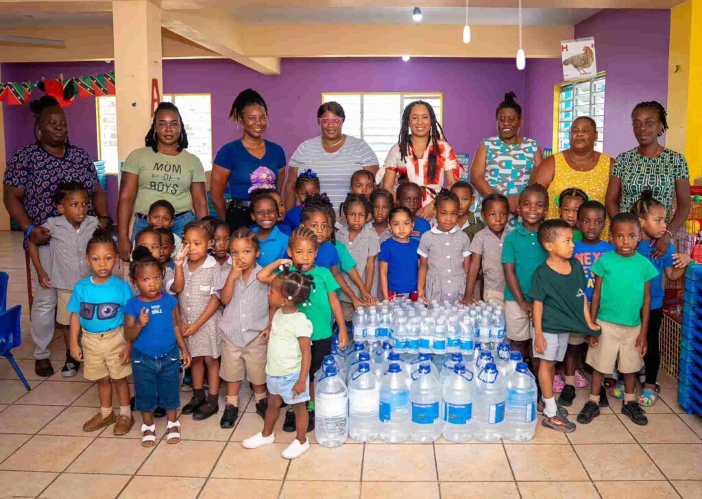 PM Terrance Drew's wife Diani donated potable water bottles in preschools and daycare for kids. (Image Credit Fb)