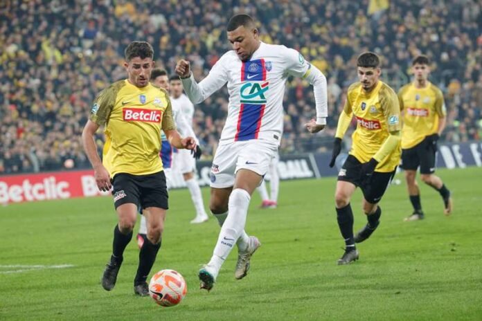 By defeating sixth-tier team Pays de Cassel with five goals in less than half an hour, Kylian Mbappe made history. With this convincing victory, PSG has advanced to the French Cup's round of 16. In addition to Mbappe's spectacular performance, Neymar and Carlos Soler each scored one goal. Estadio Bollaert-Delelis hosted the game By defeating sixth-tier team Pays de Cassel with five goals in less than half an hour, Kylian Mbappe made history. With this convincing victory, PSG has advanced to the French Cup's round of 16. In addition to Mbappe's spectacular performance, Neymar and Carlos Soler each scored one goal. Estadio Bollaert-Delelis hosted the game