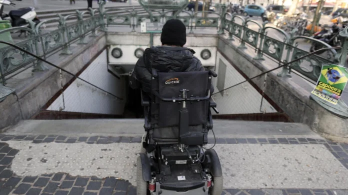 A disabled person is pictured on his wheelchair at the entrance of a metro station in Paris on February 19, 2013. © Kenzo Tribouillard, AFP