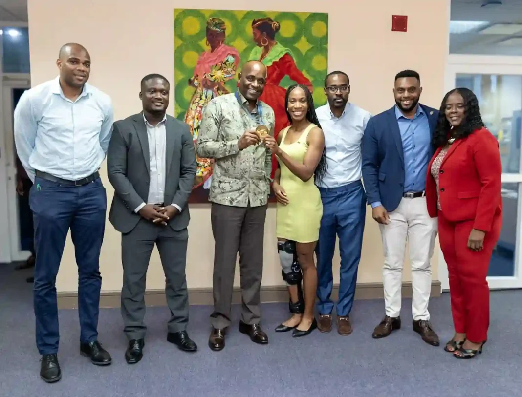 Thea LaFond Gadson gives courtesy call to Roosevelt Skerrit.