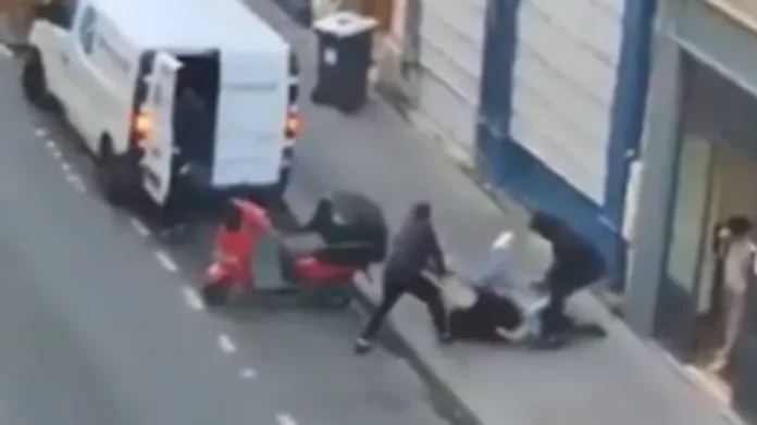 The woman can be seen grabbing a firearm from one of the attackers and throwing it into the road—police later confirmed the weapon was a replica air gun The woman can be seen grabbing a firearm from one of the attackers and throwing it into the road—police later confirmed the weapon was a replica air gun