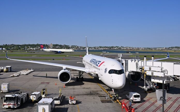 Passengers queue at Paris airport as flight cancellations rise due to a nationwide air traffic controller strike in France