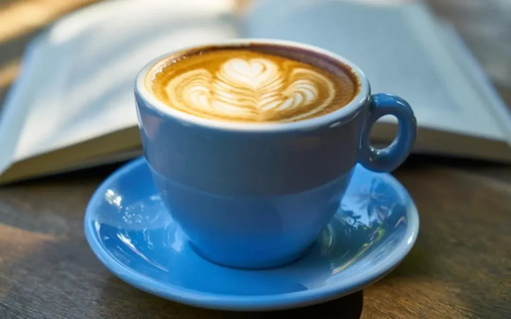 A Parisian barista prepares espresso in a modern café, blending France’s timeless coffee traditions with global brewing influences